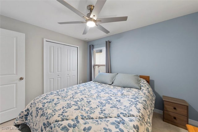 tiled bedroom featuring ceiling fan and a closet