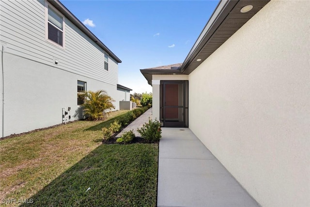 entrance to property with a lawn