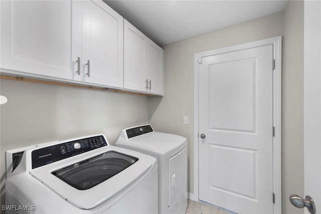 laundry room featuring cabinets and washing machine and clothes dryer