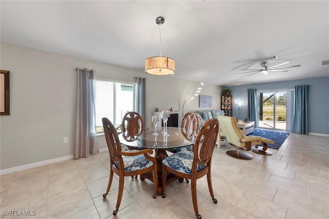 dining space with ceiling fan, plenty of natural light, and light tile patterned floors