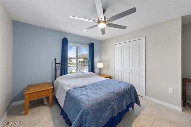 tiled bedroom with a closet and ceiling fan