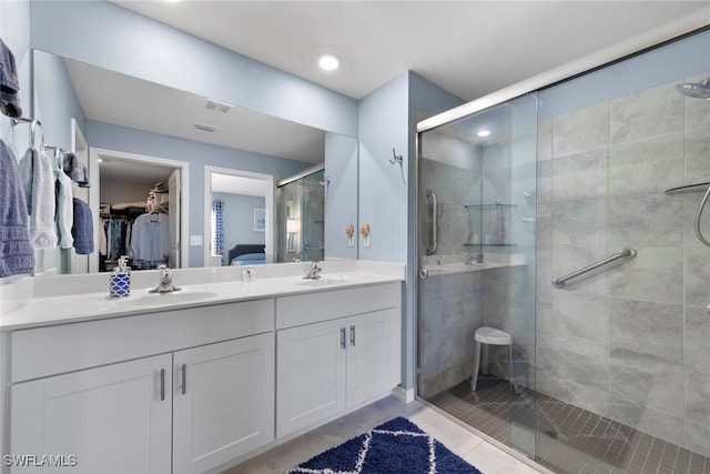 bathroom featuring walk in shower and vanity