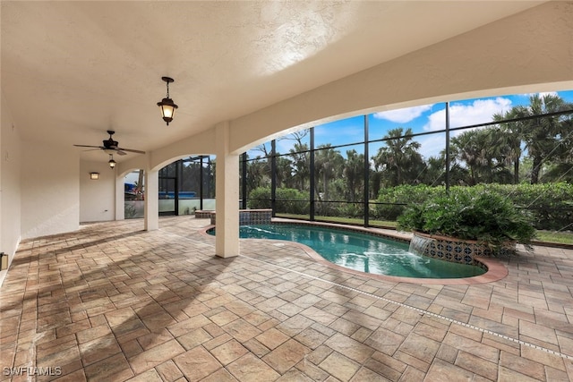 view of pool featuring pool water feature, a patio area, ceiling fan, and a lanai