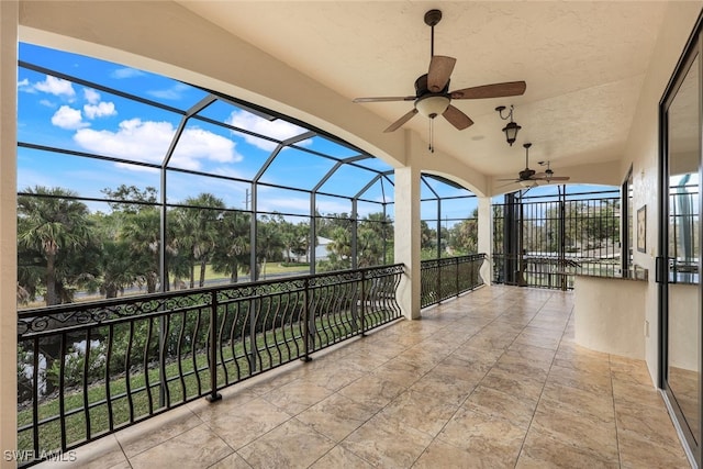 view of patio / terrace featuring a lanai and ceiling fan