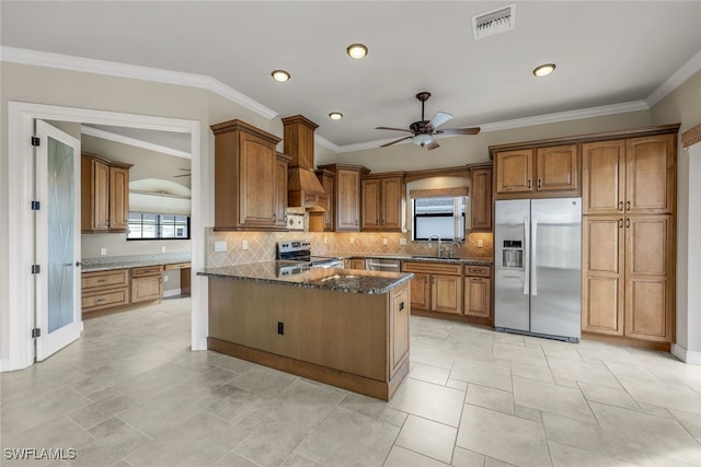 kitchen with sink, crown molding, dark stone countertops, backsplash, and stainless steel appliances