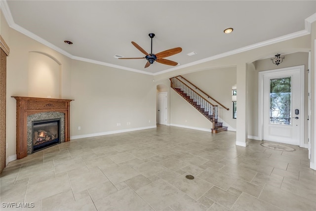 unfurnished living room with ceiling fan and ornamental molding