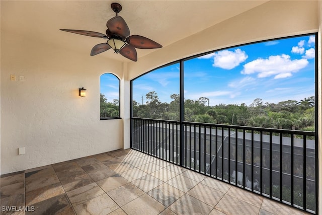 unfurnished sunroom featuring ceiling fan