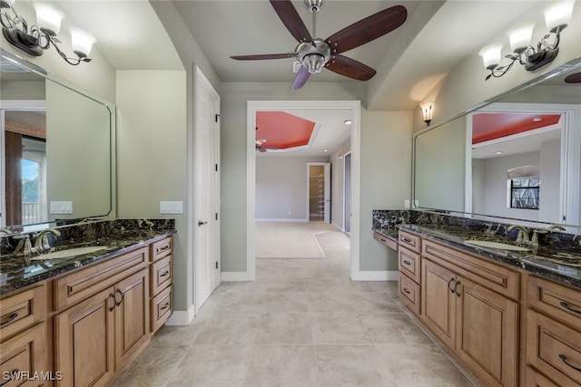 bathroom featuring vanity, a healthy amount of sunlight, and ceiling fan