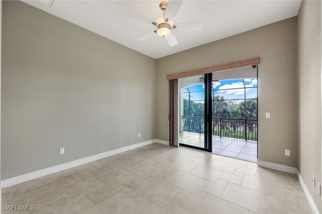 tiled spare room featuring ceiling fan