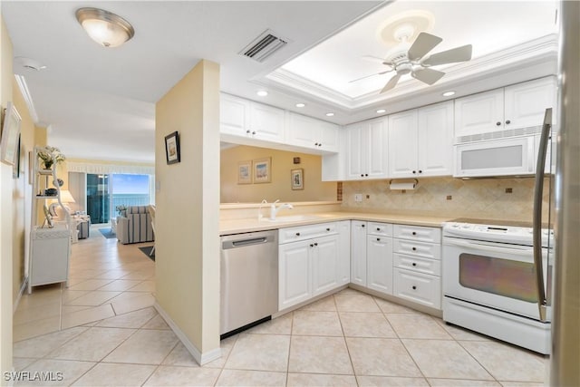 kitchen with sink, white cabinetry, light tile patterned floors, ornamental molding, and appliances with stainless steel finishes