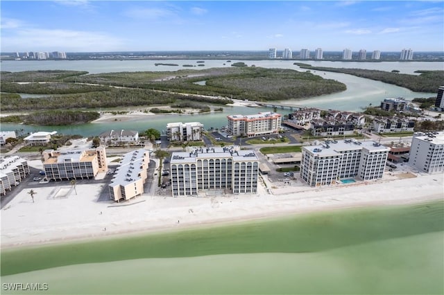 aerial view with a water view and a beach view