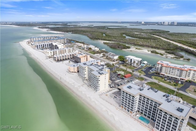 drone / aerial view featuring a water view and a view of the beach