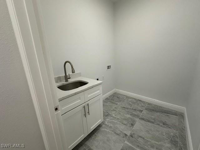 laundry area with washer hookup, cabinets, and sink