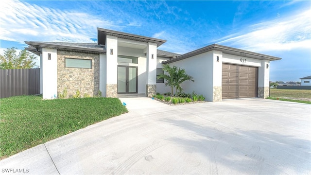 view of front of property with a front yard and a garage