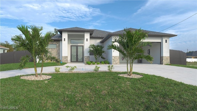 view of front facade with a garage, a front yard, and french doors