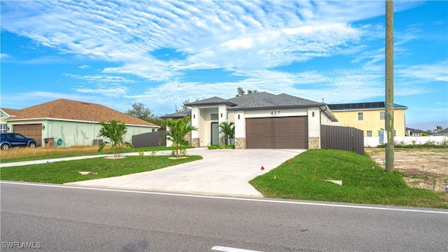 view of front facade with a front yard and a garage