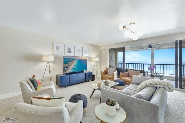 carpeted living room with a chandelier