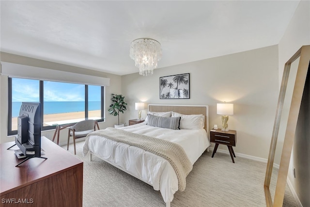 carpeted bedroom featuring a notable chandelier