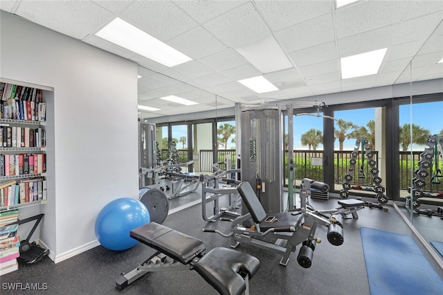 gym with a paneled ceiling