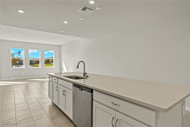 kitchen with visible vents, open floor plan, dishwasher, light tile patterned flooring, and a sink