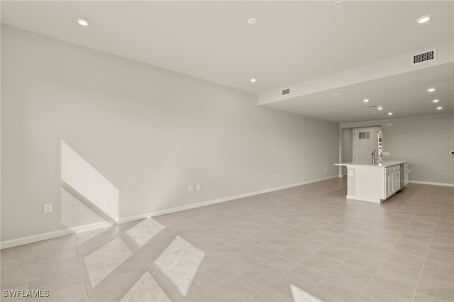 unfurnished living room featuring recessed lighting, baseboards, and visible vents