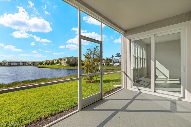 unfurnished sunroom with a water view