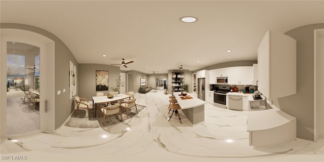 dining area with ceiling fan and sink