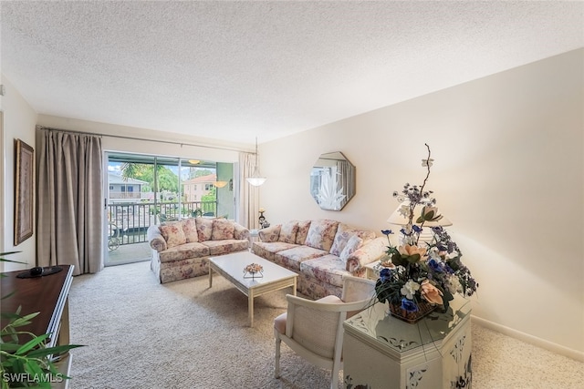 living room featuring light colored carpet and a textured ceiling