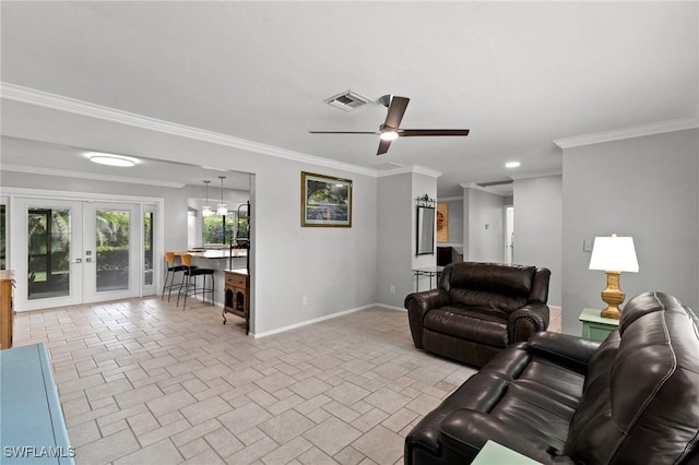 living room with crown molding, ceiling fan, and french doors