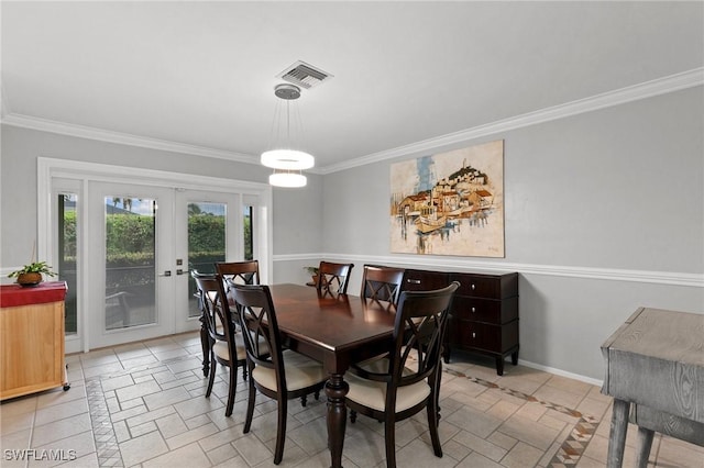 dining area featuring french doors and ornamental molding