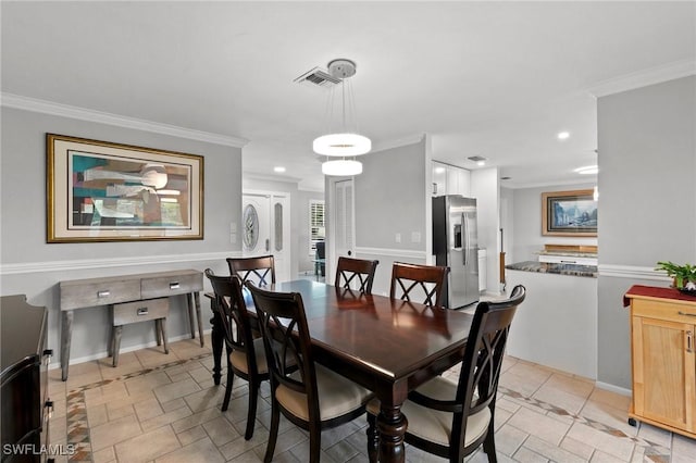 dining area featuring crown molding