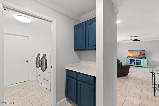 washroom featuring crown molding, ceiling fan, washer and dryer, and cabinets