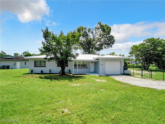 single story home featuring a front yard and a garage