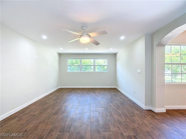 empty room featuring ceiling fan and dark wood-type flooring