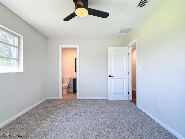 unfurnished bedroom featuring ceiling fan, carpet, and ensuite bathroom