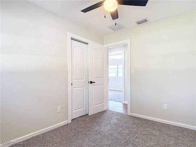 unfurnished bedroom with ceiling fan, a closet, and carpet flooring