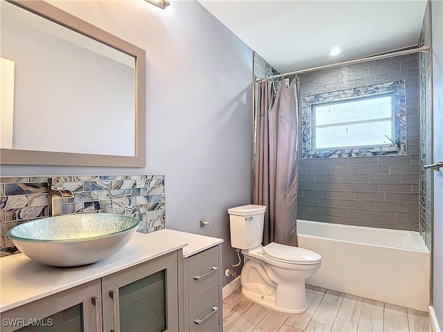 full bathroom featuring toilet, vanity, and shower / tub combo with curtain