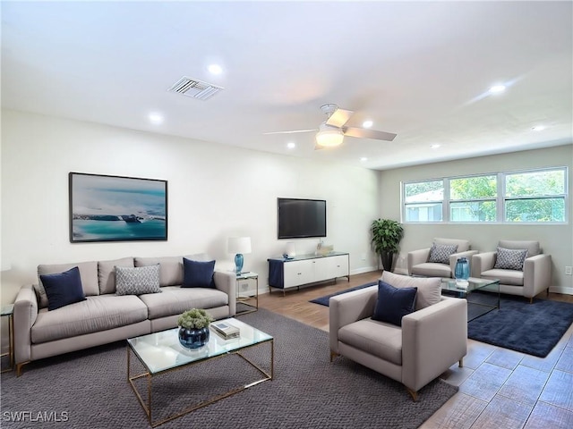 living room with ceiling fan and light wood-type flooring