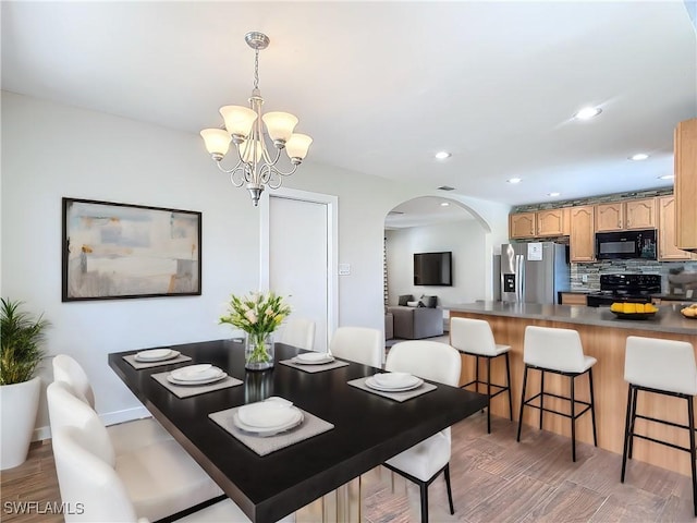 dining room featuring dark hardwood / wood-style flooring and a notable chandelier