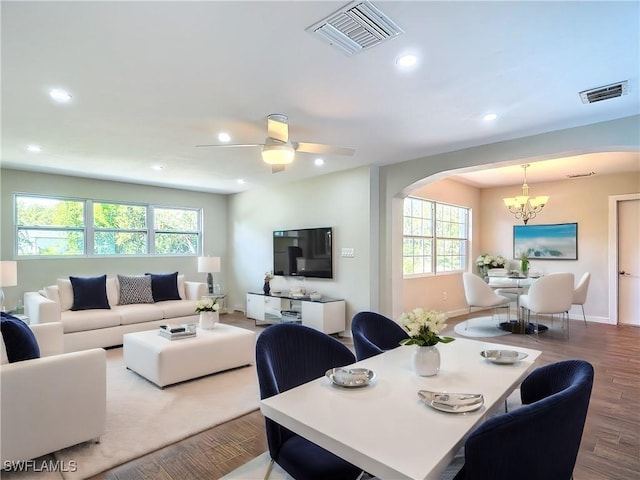 dining area featuring ceiling fan with notable chandelier and light hardwood / wood-style floors