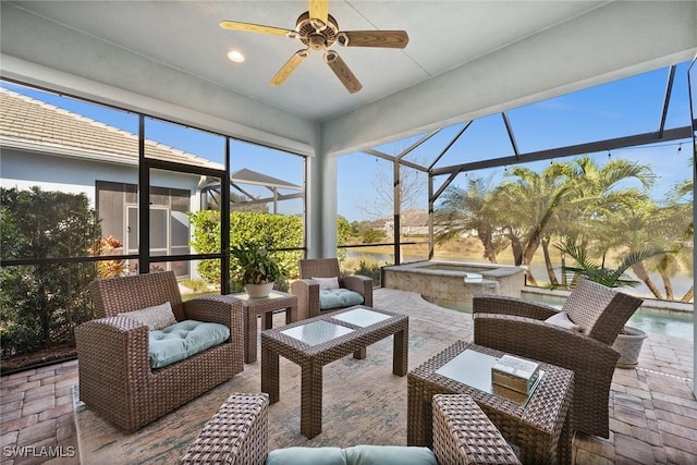 sunroom featuring a water view and ceiling fan