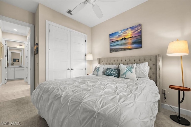 carpeted bedroom featuring ceiling fan, a closet, and connected bathroom