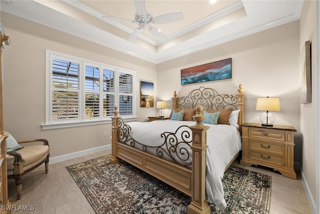 bedroom featuring ceiling fan, crown molding, and a raised ceiling