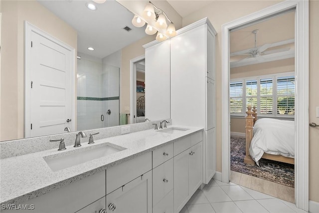 bathroom featuring walk in shower, vanity, ceiling fan, and tile patterned floors