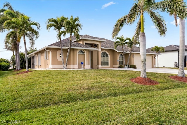 view of front of home with a front yard and a garage