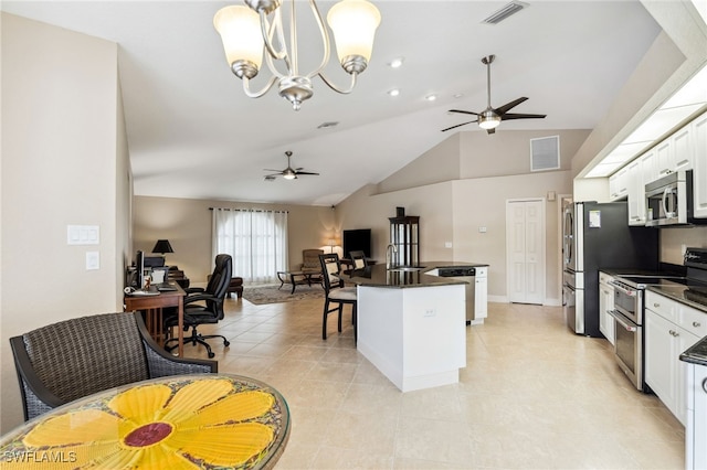 kitchen featuring lofted ceiling, ceiling fan, pendant lighting, appliances with stainless steel finishes, and white cabinets