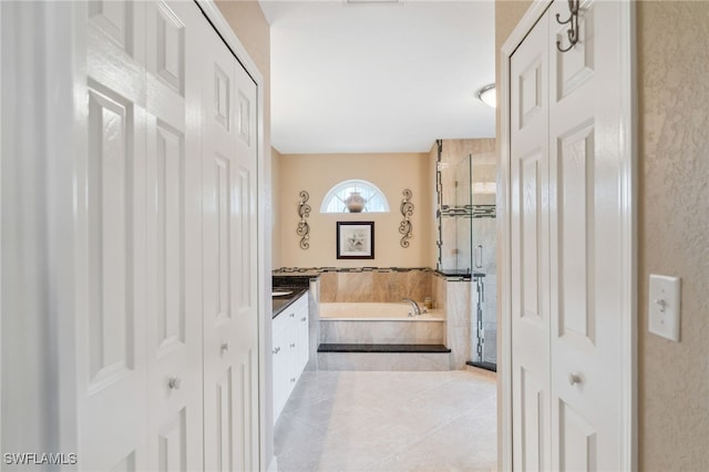 bathroom featuring tile patterned floors, vanity, and separate shower and tub