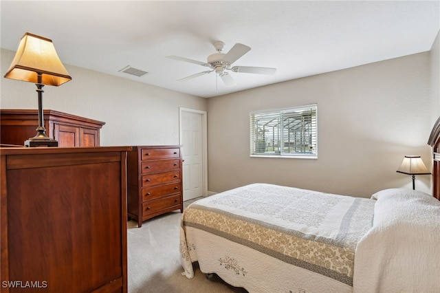 bedroom with ceiling fan and light carpet