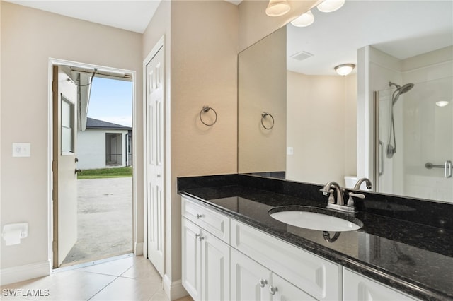 bathroom with vanity, tile patterned flooring, and a shower with door