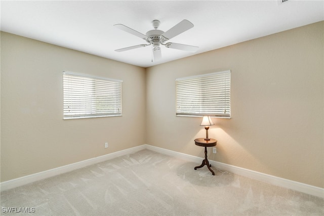 spare room with light carpet and ceiling fan